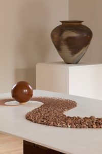 Becky Little and Tom Morton - River of Earth 2026 Clay-rich subsoil gathered from eroding coastline, Buckhaven, Fife & Nancy Fuller - St Austell Kame 2017 Anagama-fired, artist’s stoneware blend, natural ash glaze Becky Little and Tom Morton - River of Earth 2026 Clay-rich subsoil gathered from eroding coastline, Buckhaven, Fife & Nancy Fuller - St Austell Kame 2017 Anagama-fired, artist’s stoneware blend, natural ash glaze
